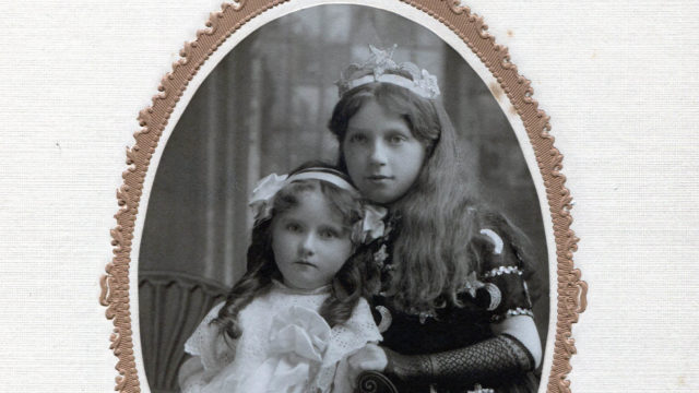 Two Victorian girls in a black and white photograph.