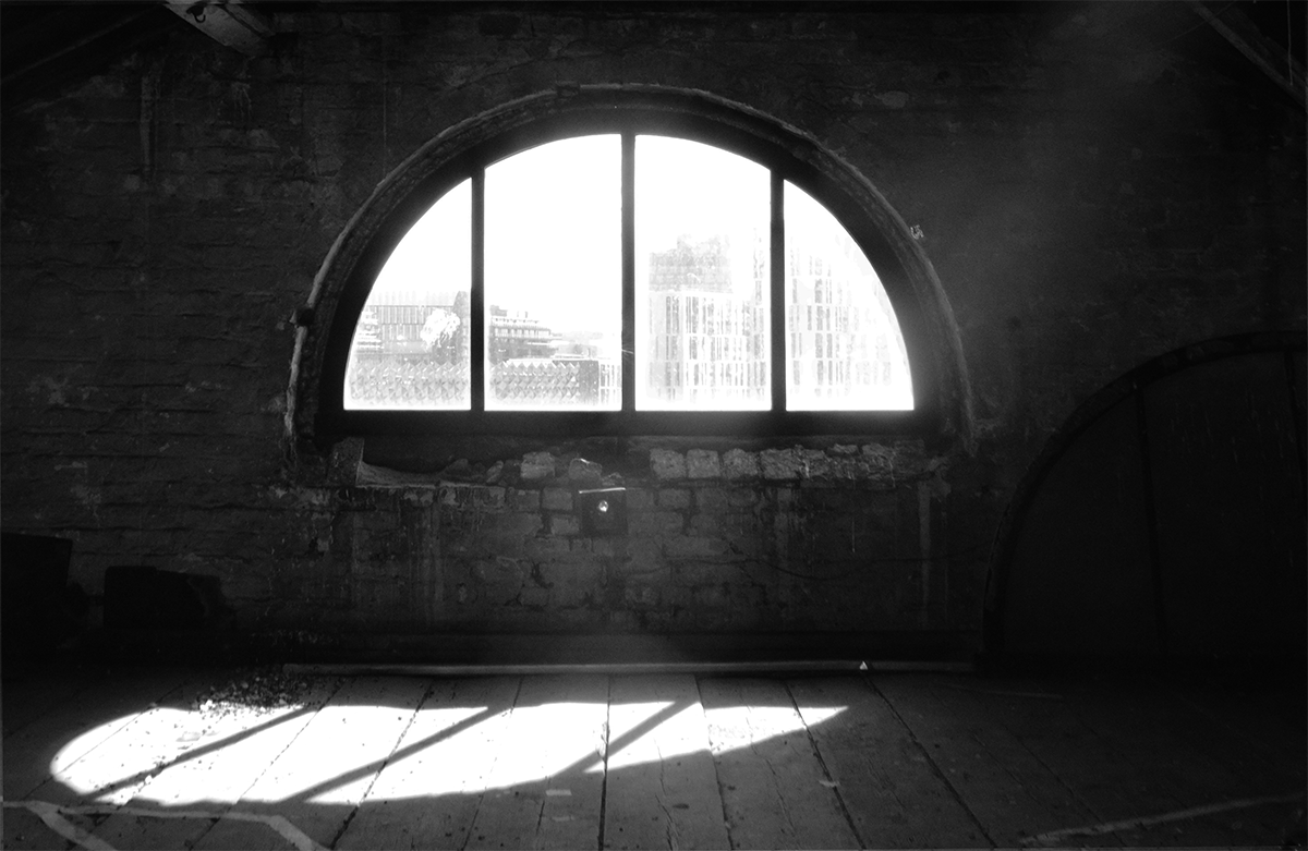A semicircular window inside an industrial building