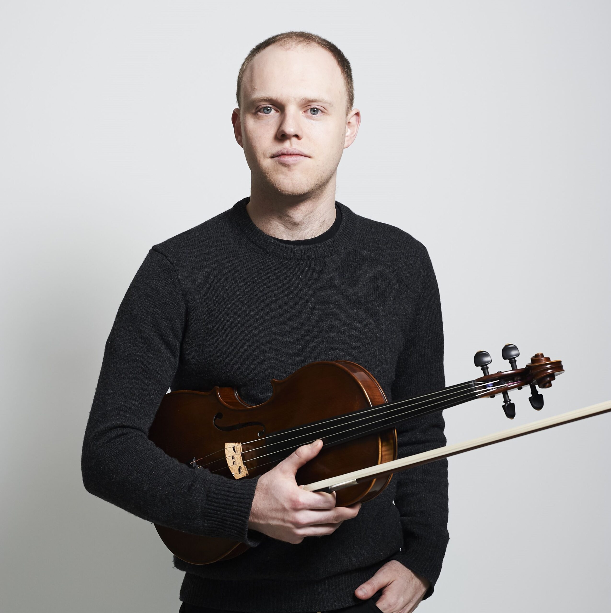 Alistair Vennart holds a viola.