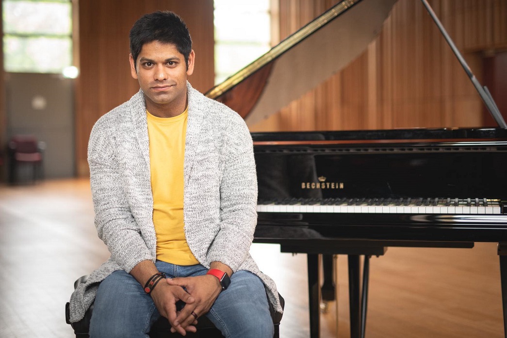 Alpesh Chauhan sitting at the piano