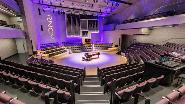 RNCM Concert Hall with piano on stage.