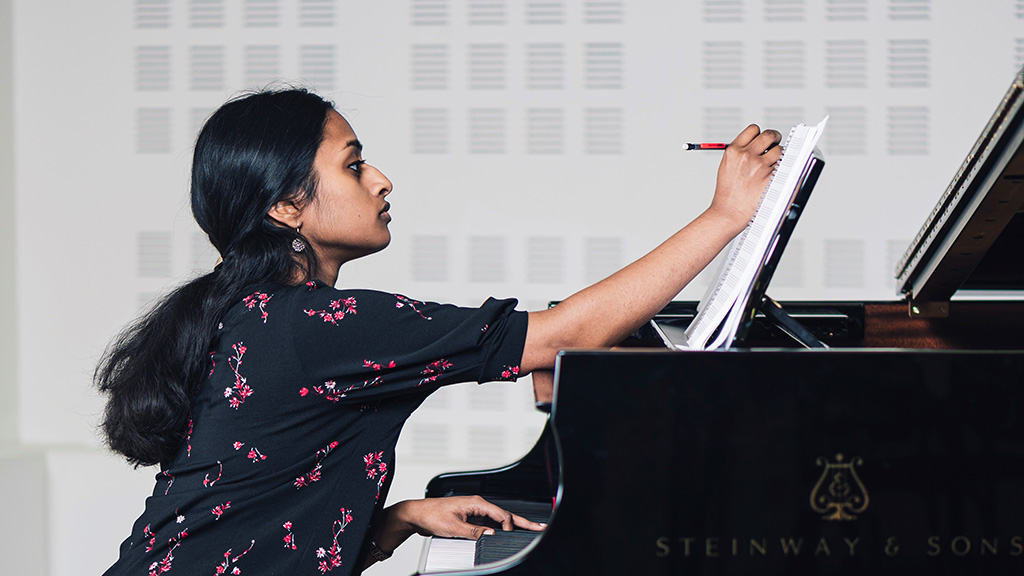 Girl at piano composing