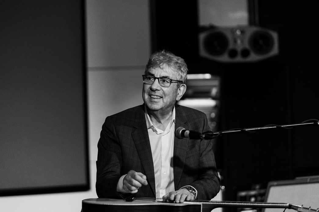 Graham Gouldman sitting with guitar