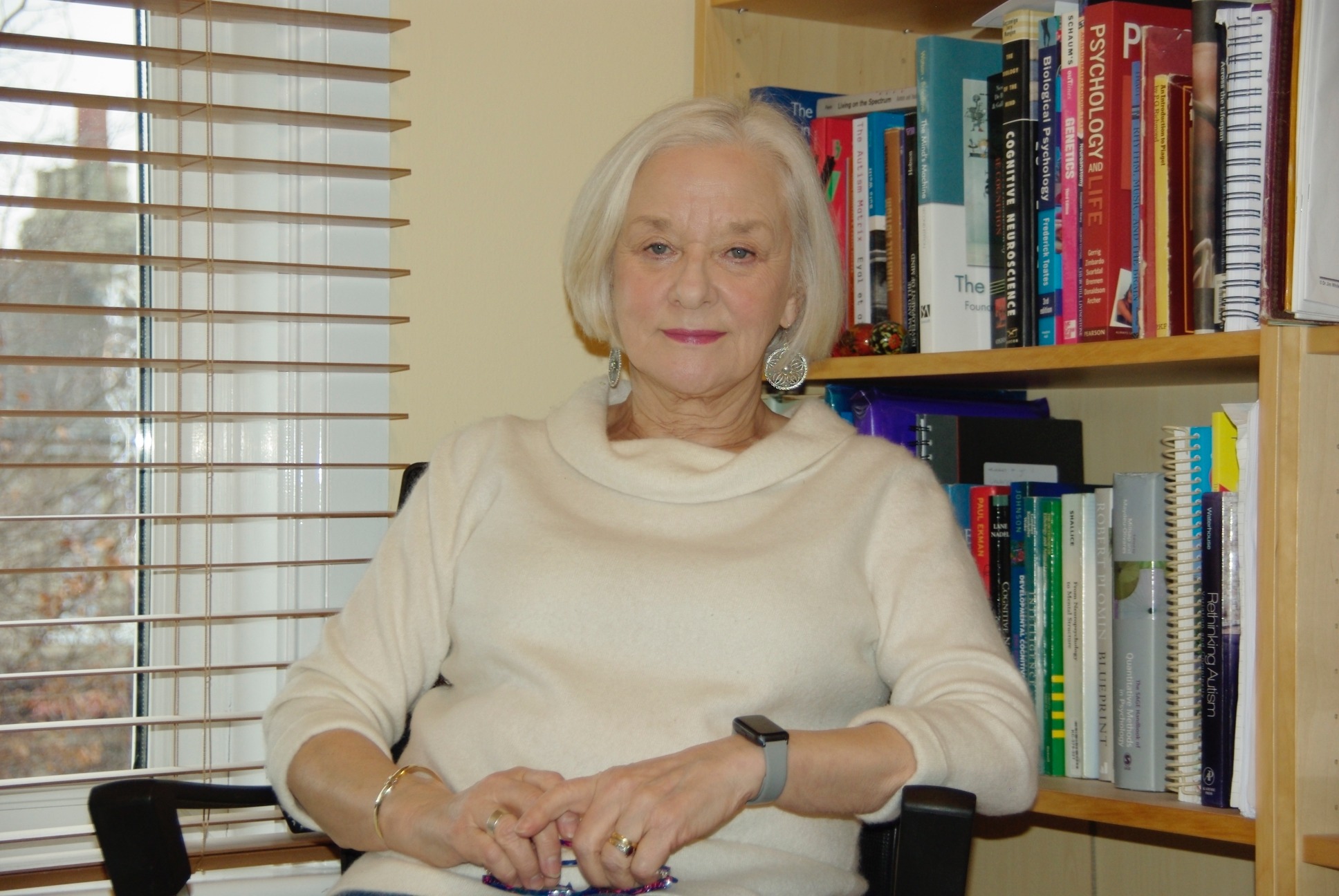 Professor Pamela Heaton sitting in front of a bookshelf.