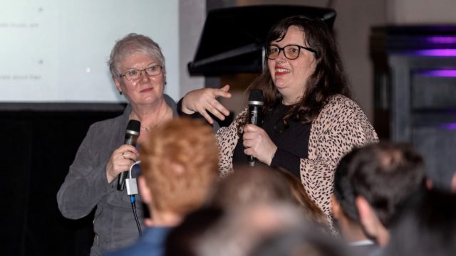 Two people talking on stage