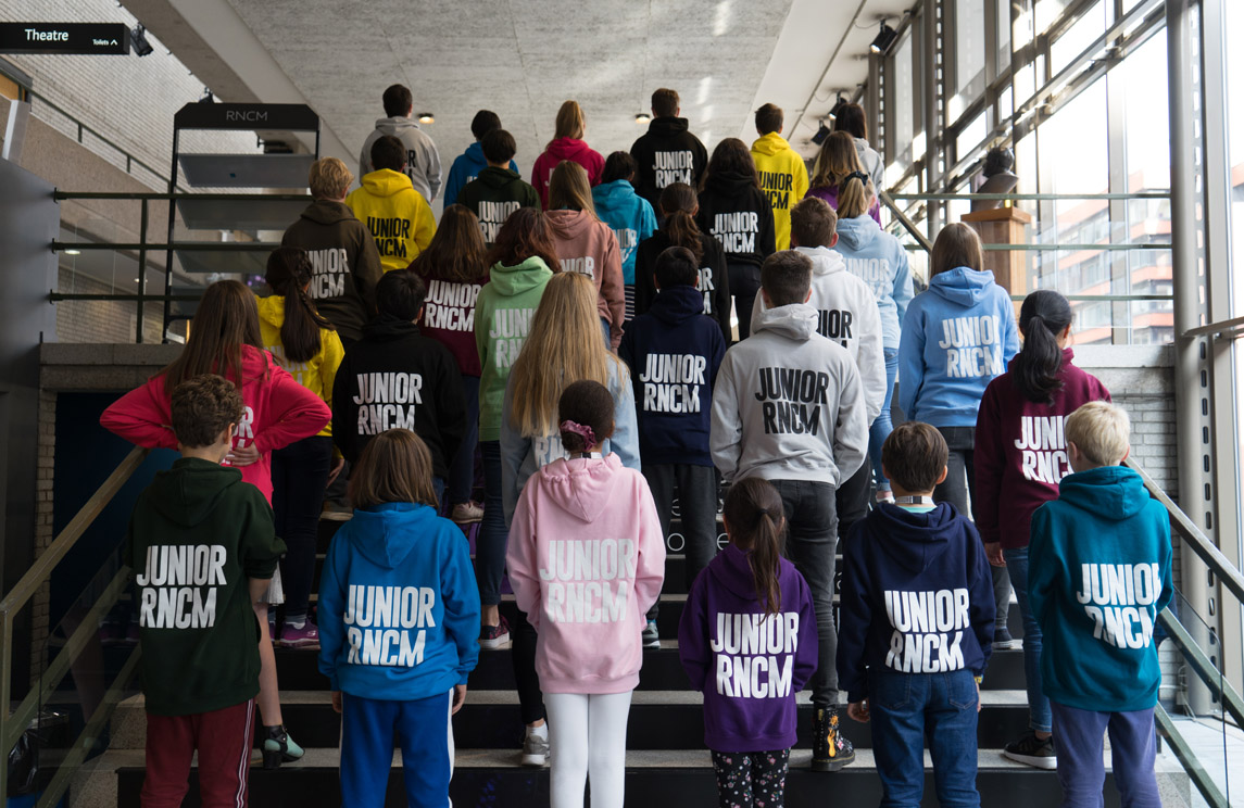Junior RNCM students in multicoloured 'Junior RNCM' hoodies