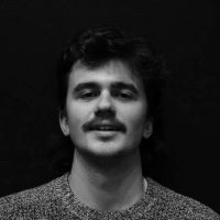 Black and white image of male with moustache