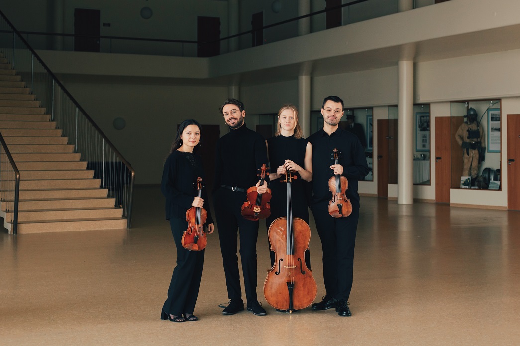 NOVO Quartet standing with instruments