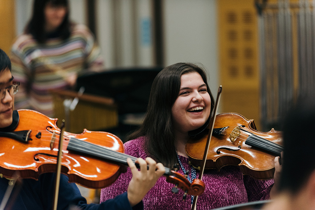 Student playing violin.