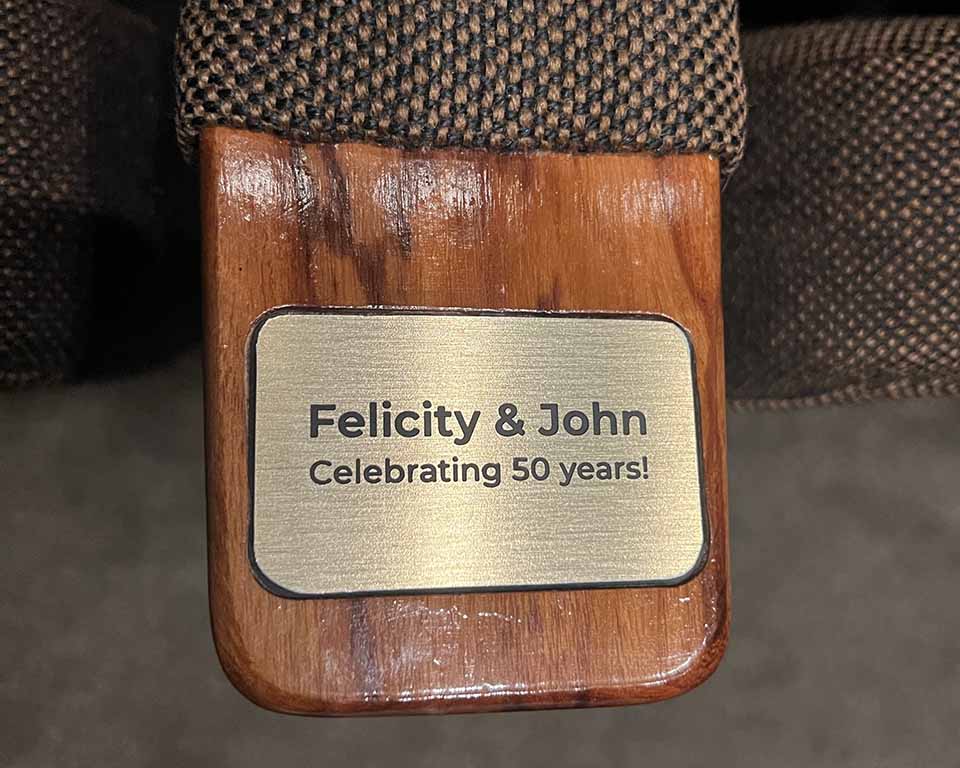 A seat plaque says Felicity and John Celebrating 50 years. 
