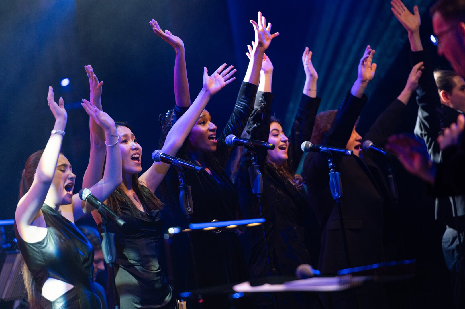 A group of singers perform on stage.