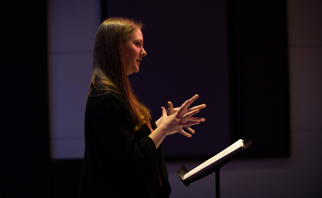 RNCM student standing in front of a stand, gesturing with their hands