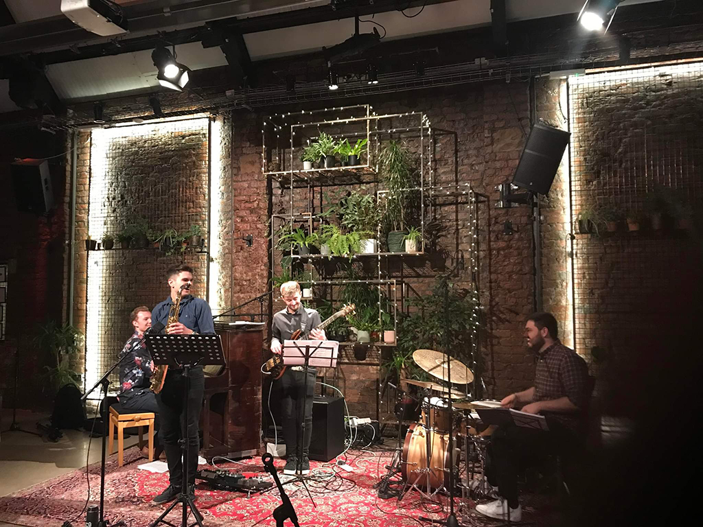 A jazz trio plays on stage. 