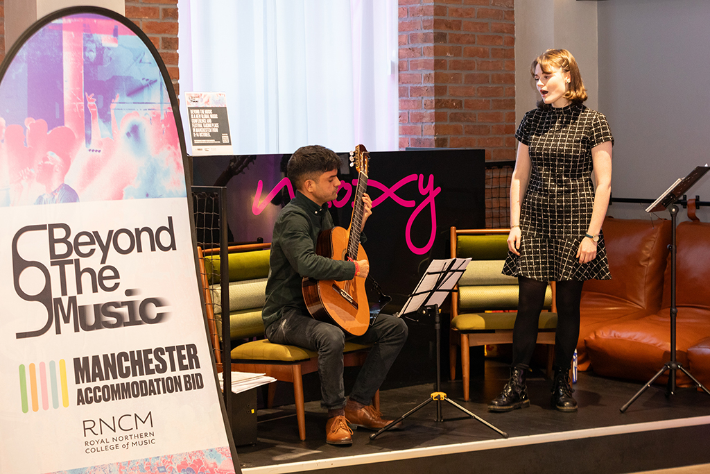 A RNCM student sings accompanied by a student playing guitar.