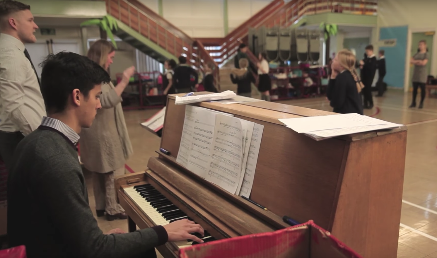 A pianist plays in a school hall.