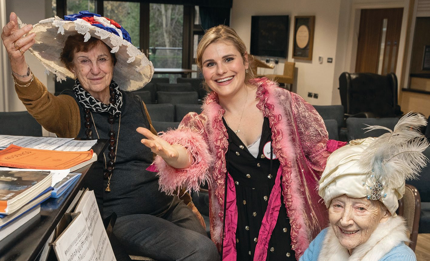 Lucy Temby with care home residents at the piano