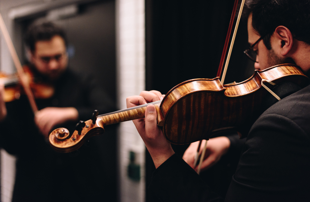 RNCM violin student practicing in front of a mirror. 