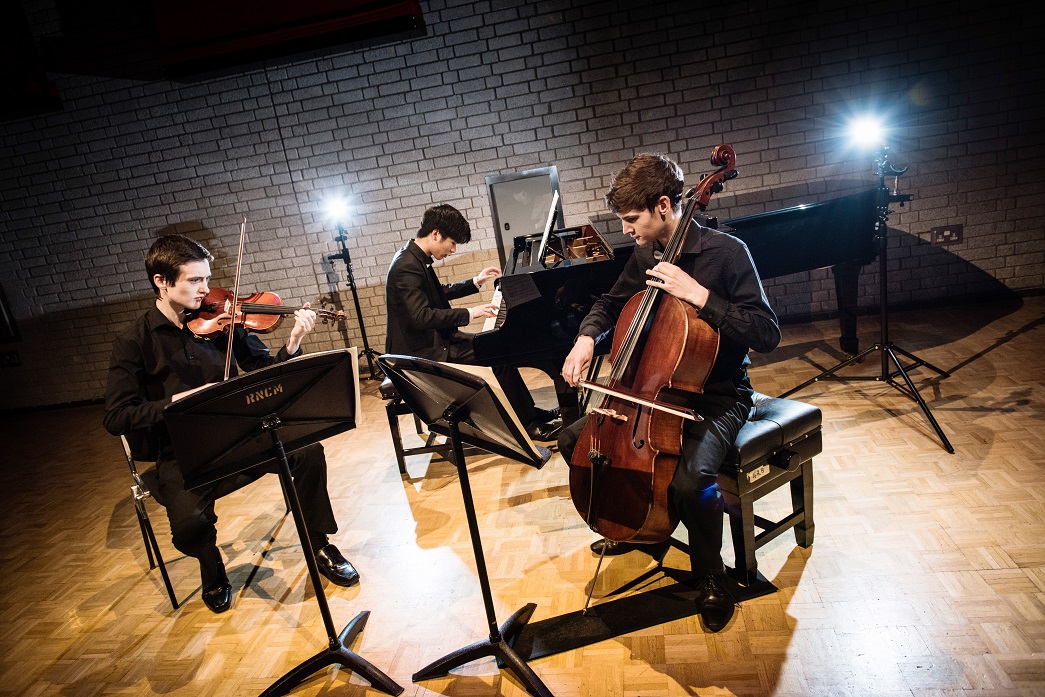 RNCM Students playing piano, violin and cello in the Carol Nash Recital Room