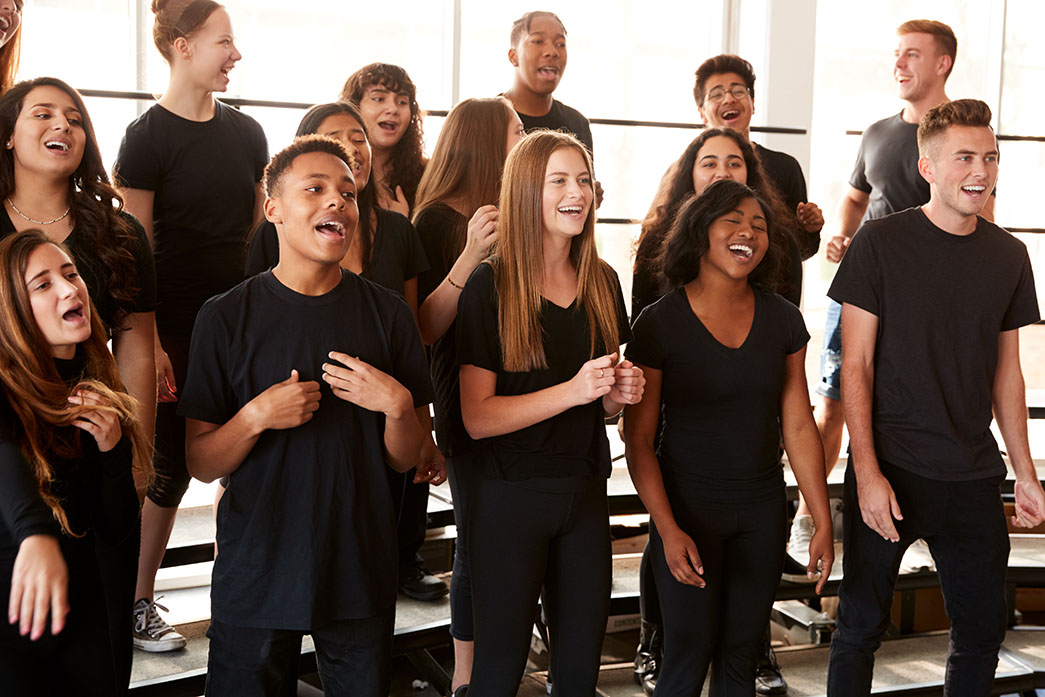 A choir of students perform.