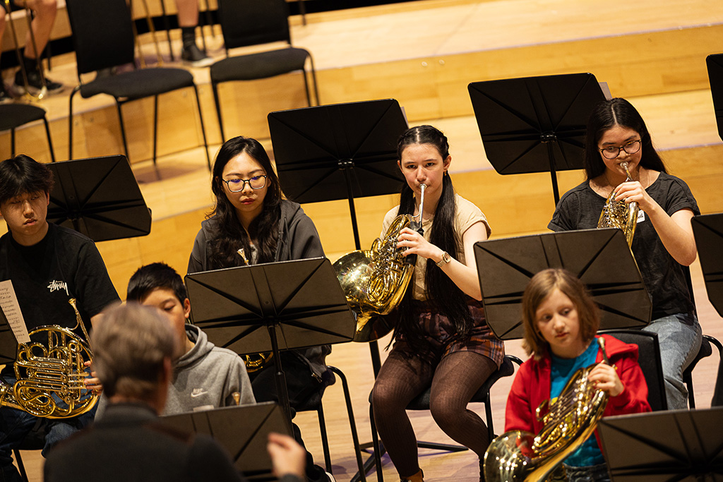 Young projects students playing horns. 