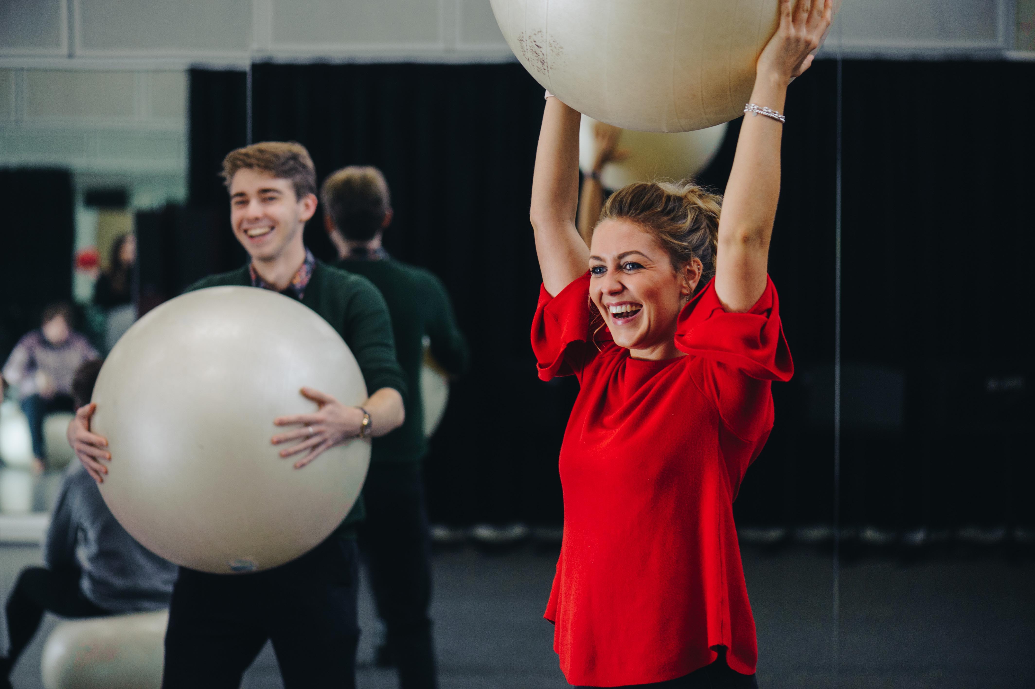 RNCM students take part in Alexander Technique class where there are holding large blow up balls. 