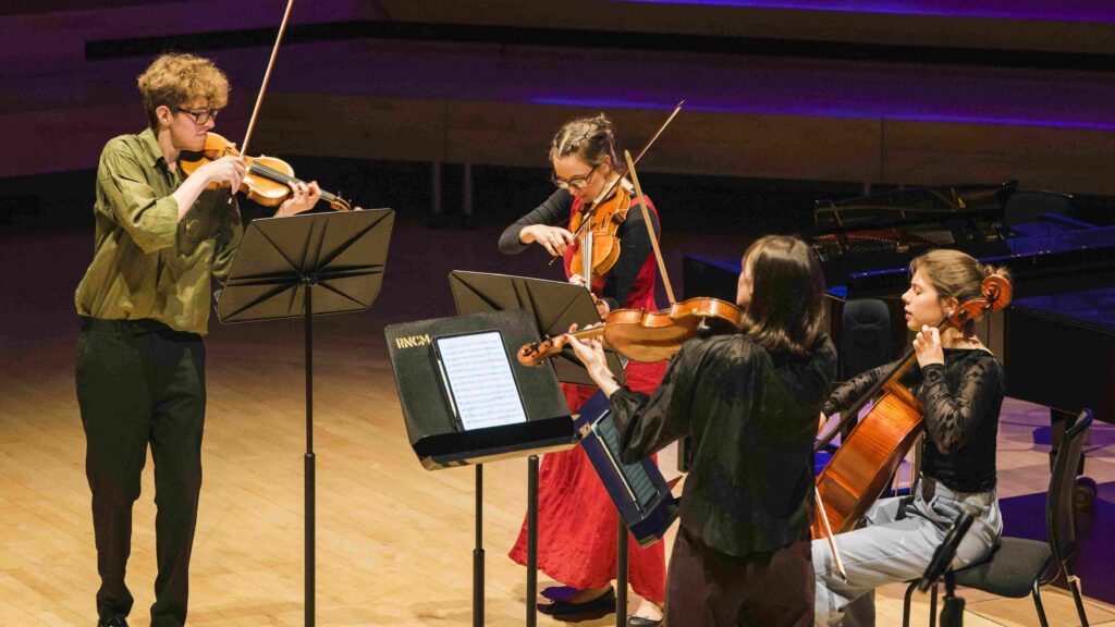 Chamber musicians performing in concert hall