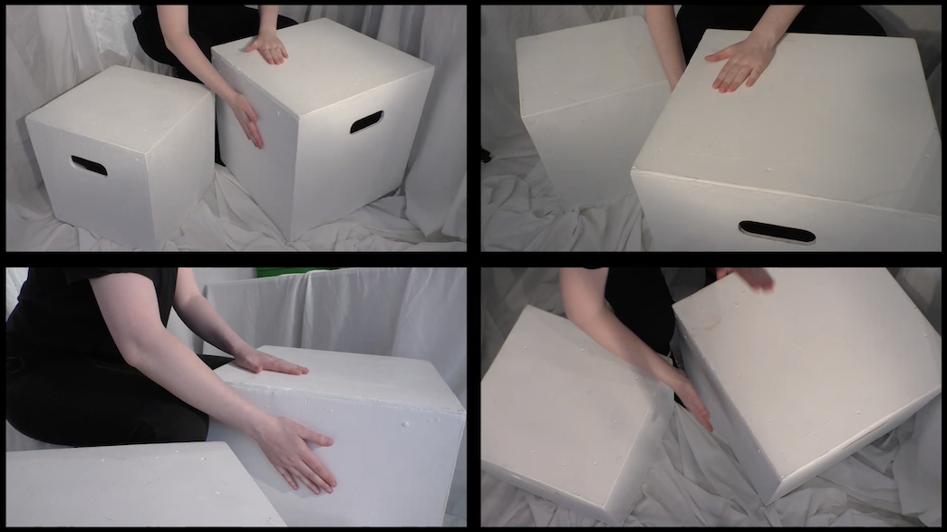 A person hitting cardboard boxes like drums