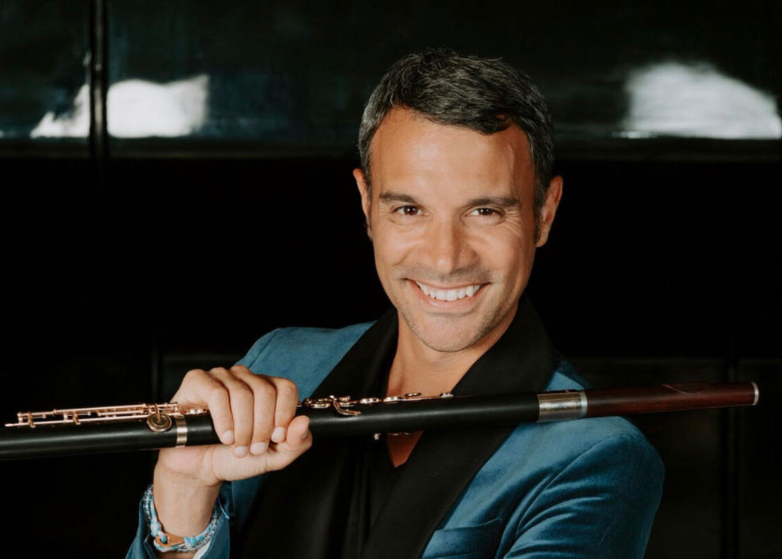 Portrait photo of Julien Beaudiment with a wooden flute